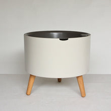 thirstypot round planter with short legs studio shot from front