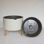 thirstypot round planter with short legs next to basket