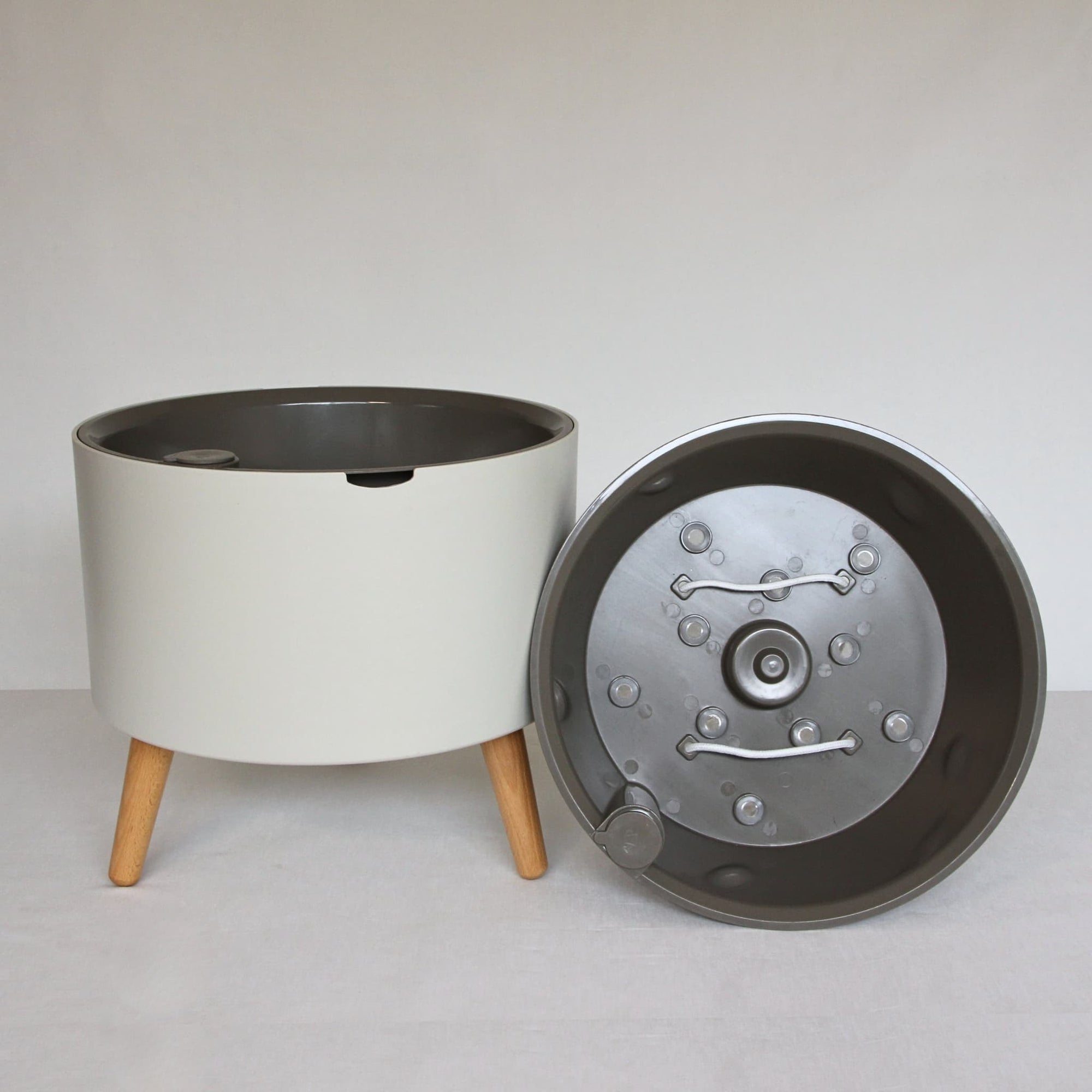 thirstypot round planter with short legs next to basket